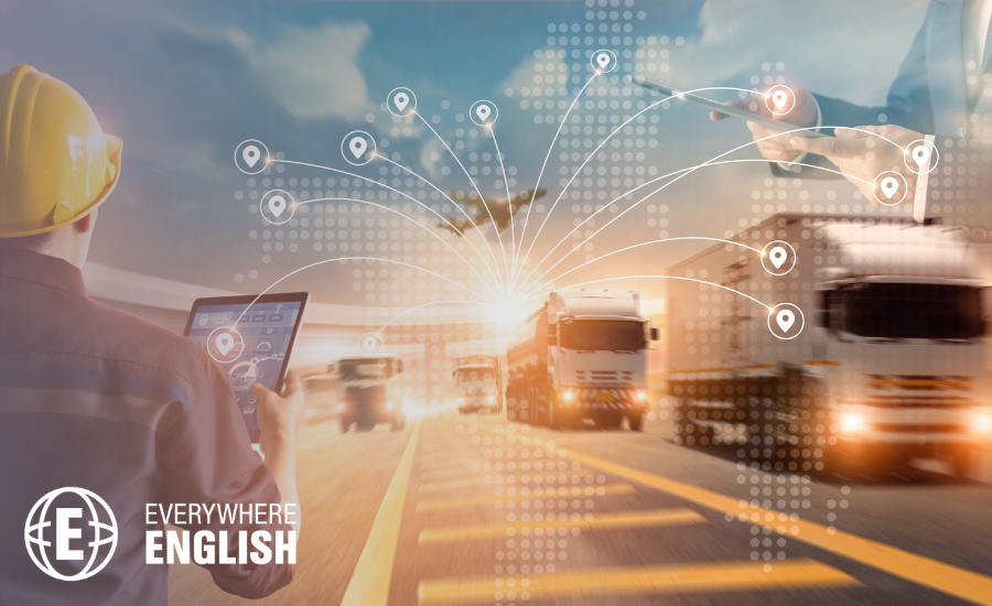 A person with a tablet monitors logistics; lorries drive on a road with a digital map overlay showing location tracking - illustrating transport management and the importance of English for the Logistics Industry: Key Phrases you Should Know