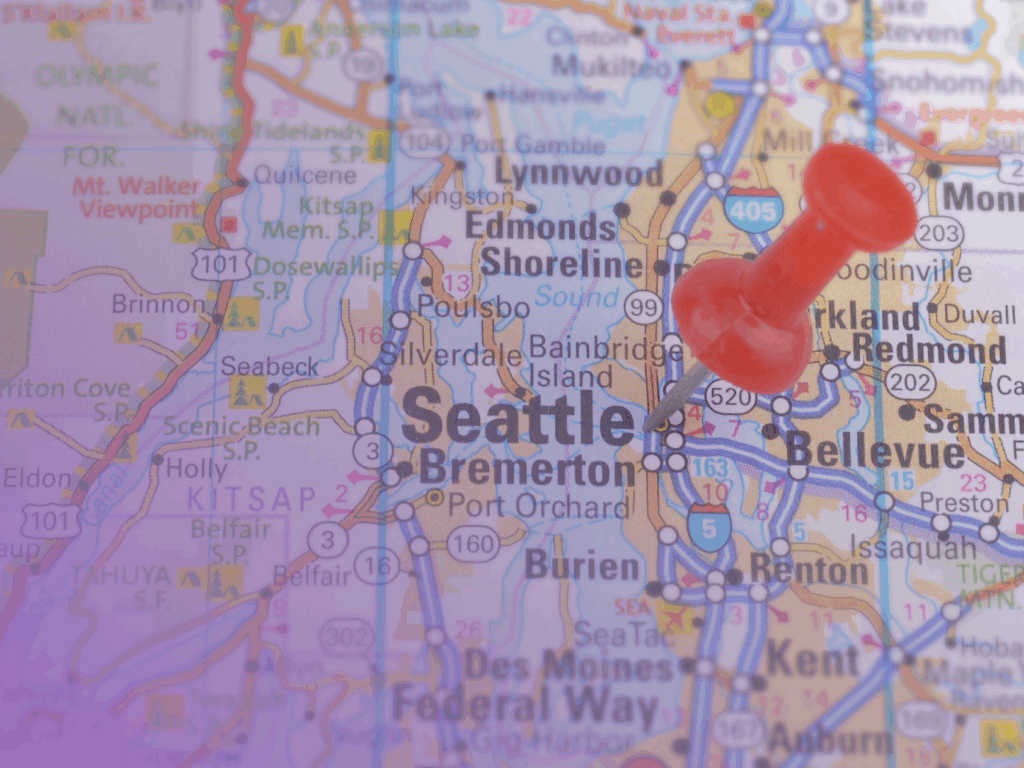 A map of the Seattle area with a red drawing pin marking the city of Seattle. Highlight how investing in English lessons in Seattle can boost your workforce, with surrounding areas and motorways also visible.