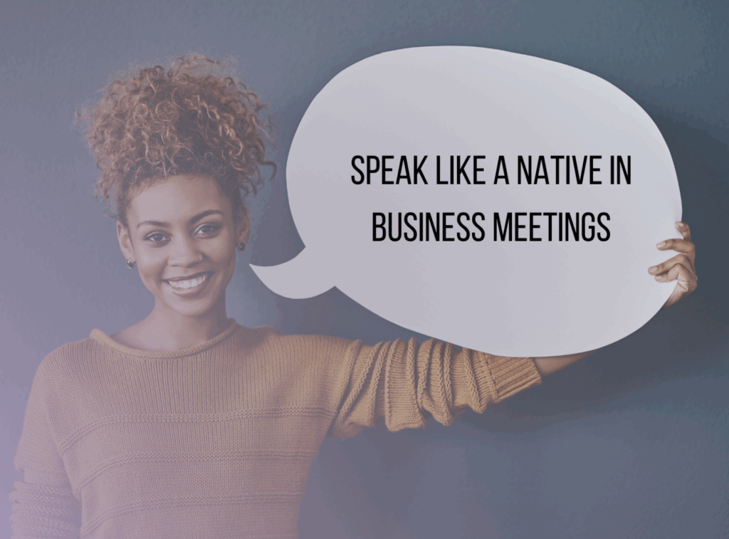 A woman holding a speech bubble sign that reads, "Speak like a native in business meetings," stands against a plain background, highlighting the Top 20 Native Phrases to Use in Business Meetings for Effective Communication.